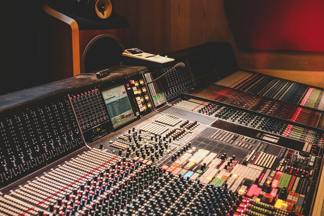 Broadcast control room with multiple video monitors and switcher panel